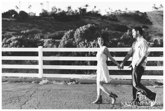 Black and White Photo of Couple Walking While Holding Hands | San Diego Engagement Photographer | Kristine Marie Photography