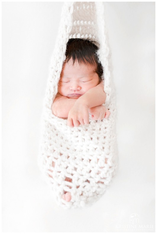 Newborn Baby Hanging in Crochet Pouch Photo | San Diego Newborn Baby Photographer | Kristine Marie Photography