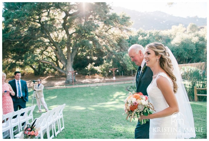 Bride walks down the aisle with her father | Temecula Creek Inn Wedding Photo | Temecula Wedding Photographer | Kristine Marie Photography | © www.kristinemariephotography.com