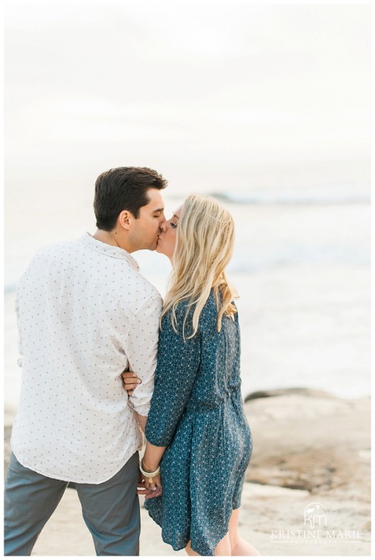 Stylish Couple Kissing  Windandsea Beach Engagement Photo | La Jolla Wedding Photographer | Kristine Marie Photography | © www.kristinemariephotography.com