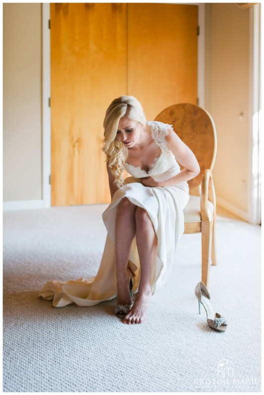 Bride putting on Betsey Johnson Wedding Shoes | Fairbanks Ranch Country Club Wedding Photos | Kristine Marie Photography © www.kristinemariephotography.com