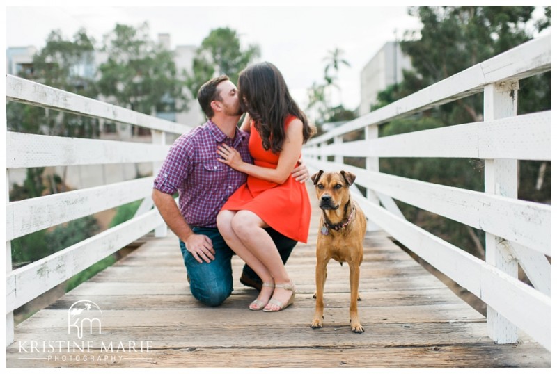 Engaged couple kissing on bridge | Murphy Canyon San Diego Engagement Photo | Kristine Marie Photography | © www.kristinemariephotography.com