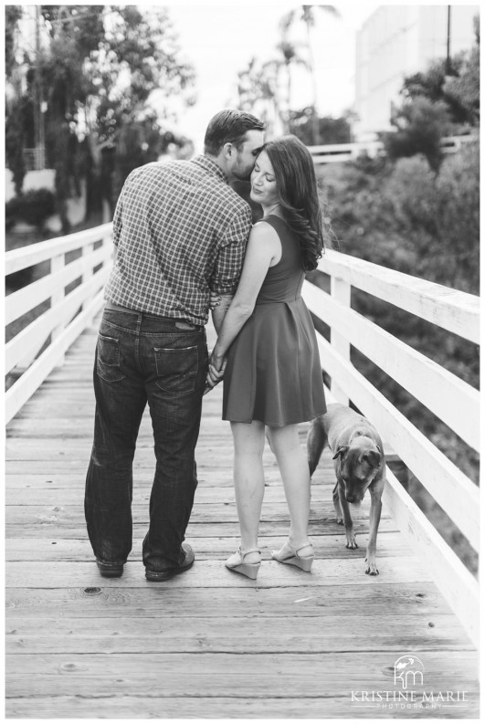 Couple kissing on bridge | Murphy Canyon San Diego Engagement Photo | Kristine Marie Photography | © www.kristinemariephotography.com