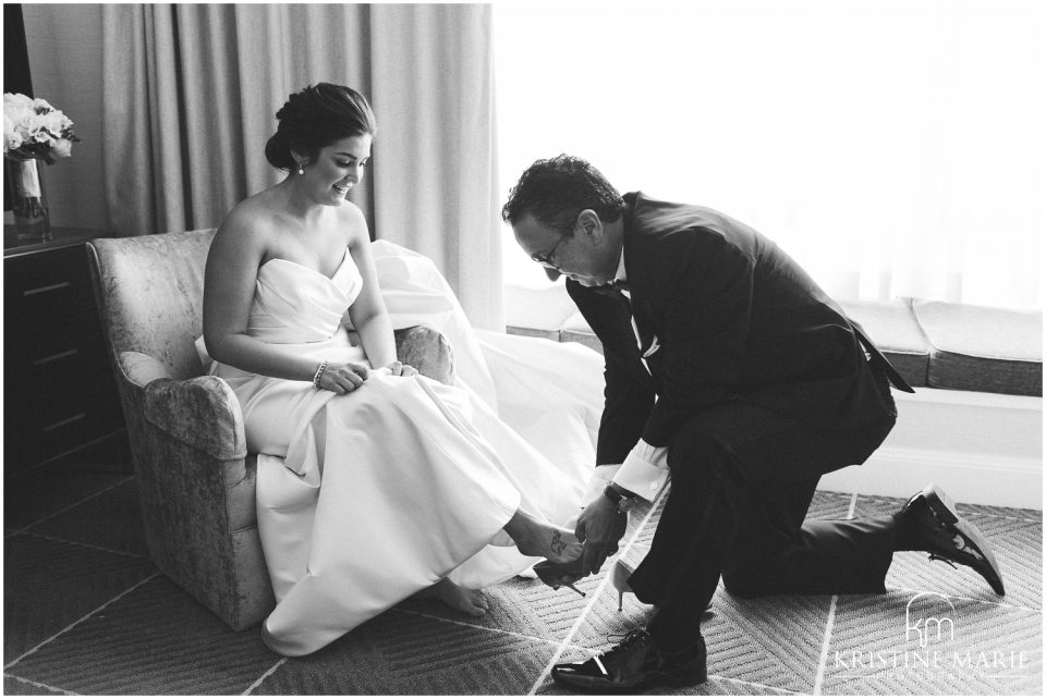 Father of Bride Puts daughter's Shoes on | Four Seasons Hotel San Francisco Wedding Photo | © Kristine Marie Photography