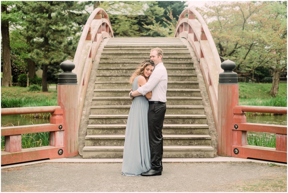 Couple hugging red bridge | Yokosuka Tokyo Family Couples Photographer | © Kristine Marie Photography 