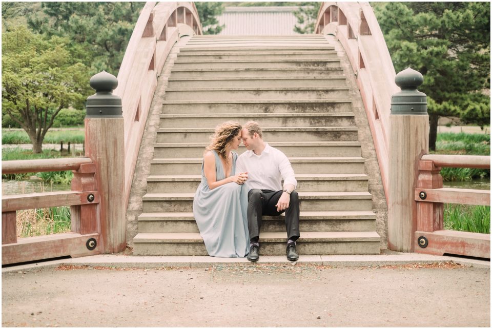 Couple sitting on bottom of red bridge | Yokosuka Tokyo Family Couples Photographer | © Kristine Marie Photography 