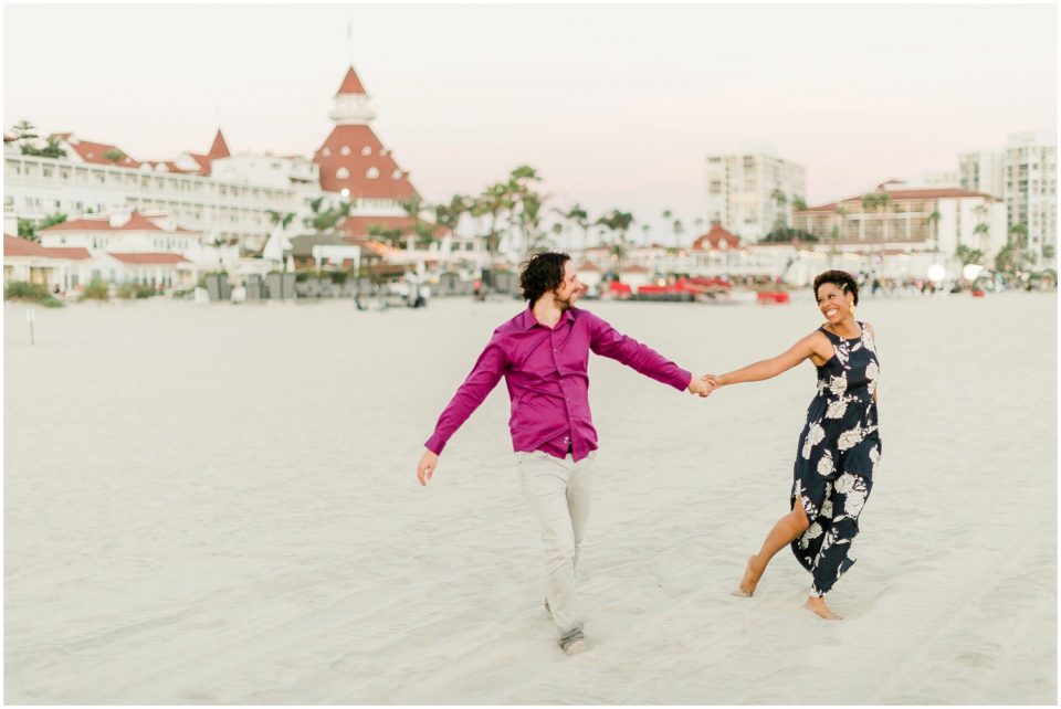 couple having fun beach Hotel Del coronado Beach Engagement Pictures San Diego Engagement Photographer Kristine Marie Photography