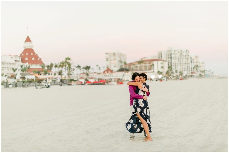 engaged couple embracing Hotel Del coronado Beach Engagement Pictures San Diego Engagement Photographer Kristine Marie Photography