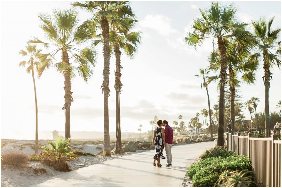 couple kissing under palm trees Hotel Del coronado Beach Engagement Pictures San Diego Engagement Photographer Kristine Marie Photography