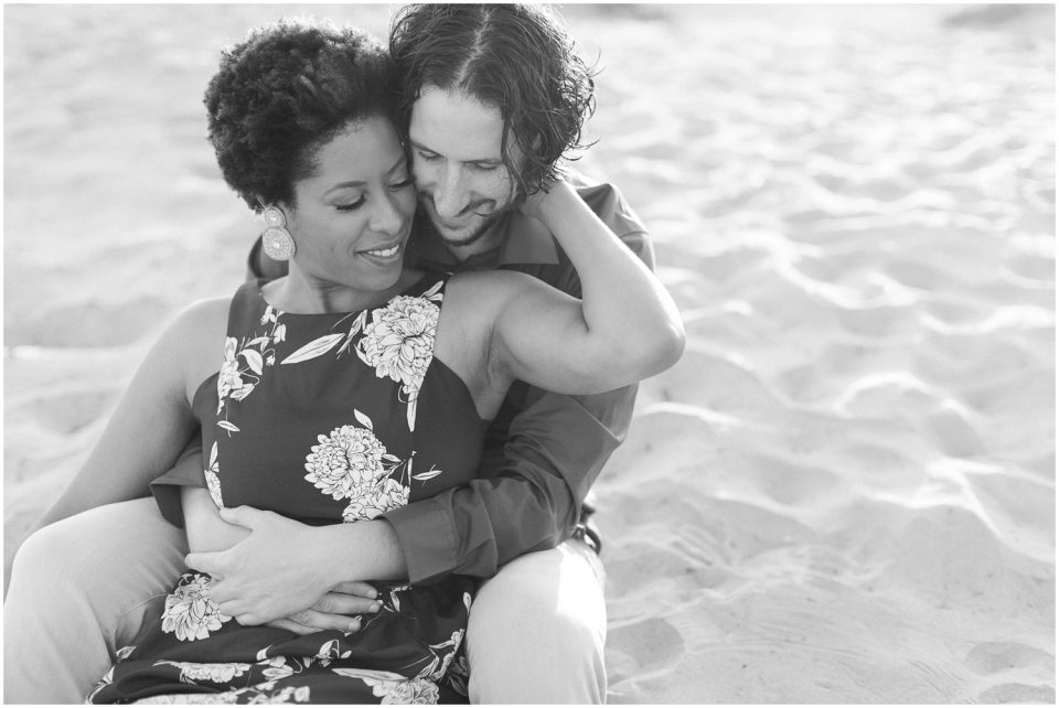 black and white photo couple sitting on the beach Hotel Del coronado Beach Engagement Pictures San Diego Engagement Photographer Kristine Marie Photography