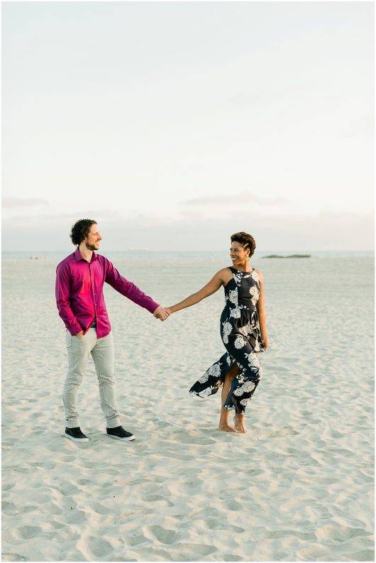 white sand beaches couple holding hands Hotel Del coronado Beach Engagement Pictures San Diego Engagement Photographer Kristine Marie Photography