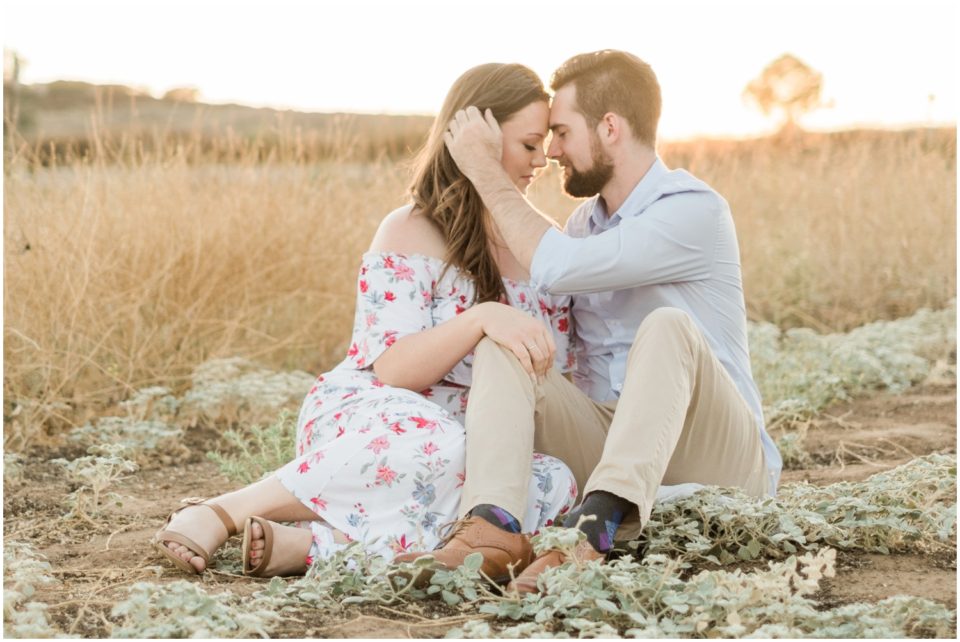 couple sitting in an open field at sunset photo  | San Diego Engagement Photography | © Kristine Marie Photography