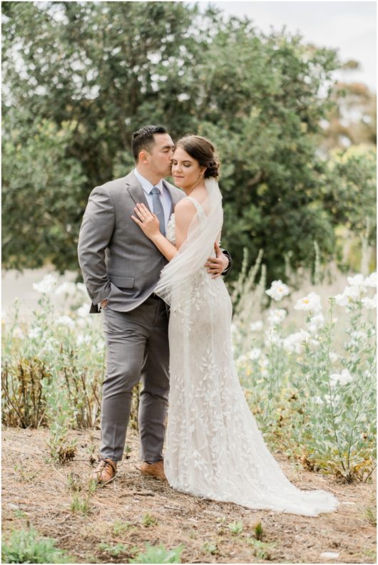 Bride and Groom in Field of White Flowers Picture | Carlsbad Wedding Photographer | © Kristine Marie Photography