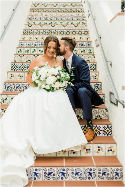 groom whispering in bride's ear Spanish steps photo | Ole Hanson Beach Club San Clemente Wedding Photographer | © Kristine Marie Photography