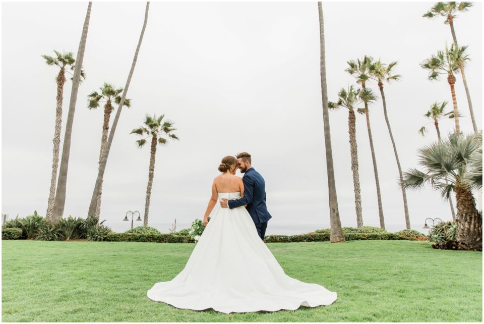 bride and groom ocean view palm trees photo | Ole Hanson Beach Club San Clemente Wedding Photographer | © Kristine Marie Photography