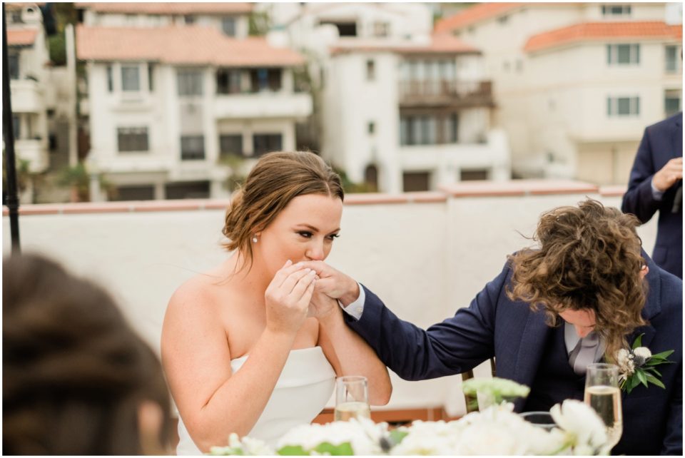 bride kissing groom's hand photo | Ole Hanson Beach Club San Clemente Wedding Photographer | © Kristine Marie Photography