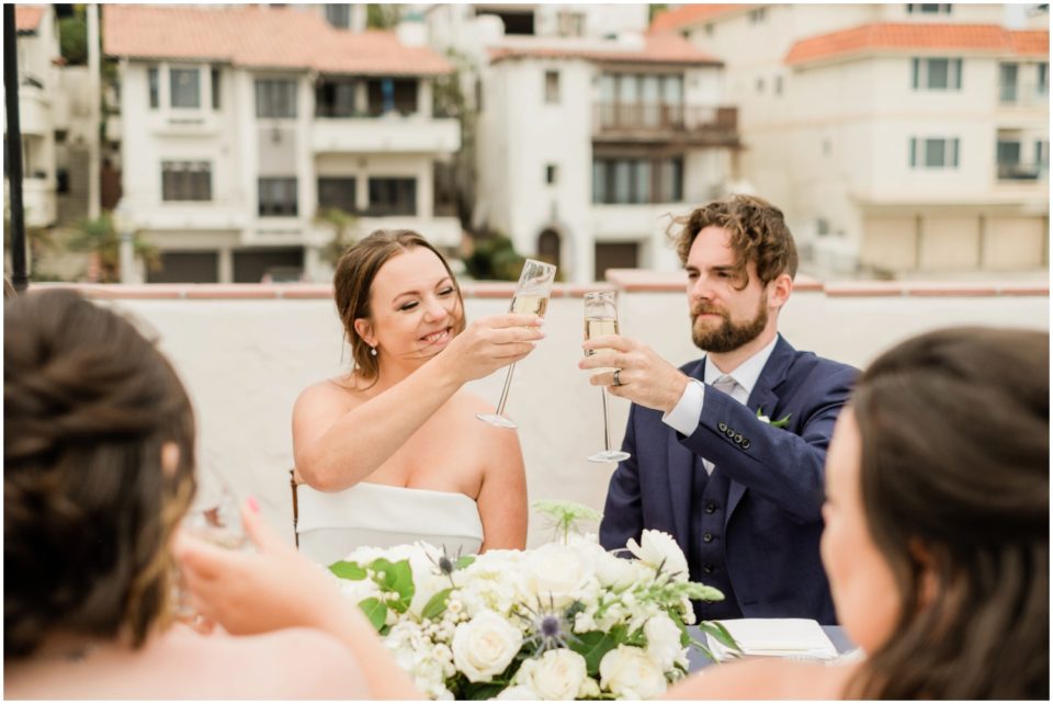 bride and groom cheers champagne glass photo | Ole Hanson Beach Club San Clemente Wedding Photographer | © Kristine Marie Photography